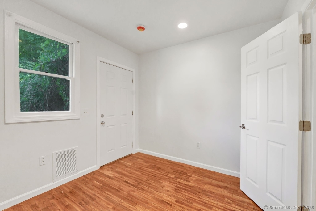 100 Mt Pleasant Street Derby, CT 06418 - Photo 31 of 40 a view of empty room with wooden floor and fan