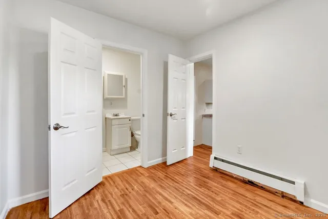 a bedroom with a bed and bathroom