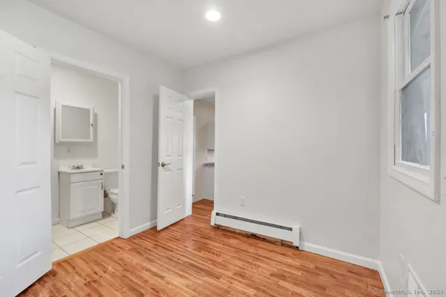 a bedroom with a bed and a view of bathroom