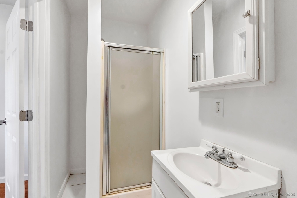 100 Mt Pleasant Street Derby, CT 06418 - Photo 36 of 40 a bathroom with a sink a mirror and a toilet