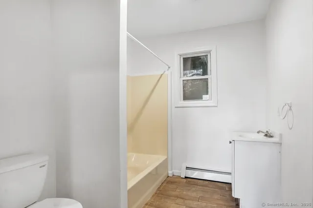 a bathroom with a granite countertop window and a white door