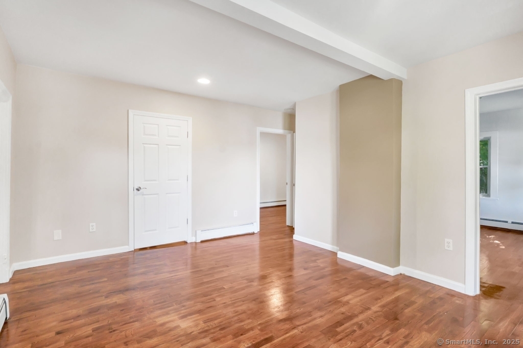 100 Mt Pleasant Street Derby, CT 06418 - Photo 4 of 40 an empty room with wooden floor & windows and bathroom
