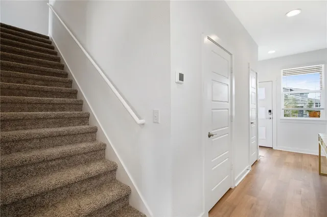 a view of an entryway with wooden floor