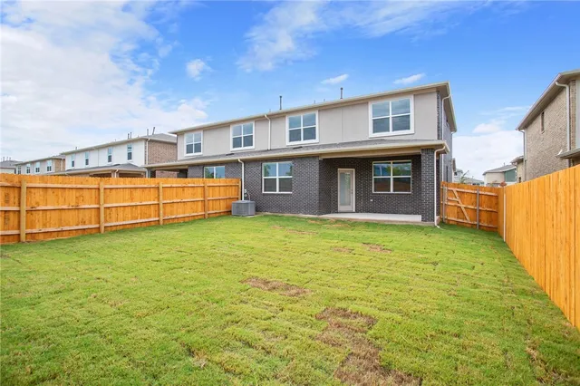 a view of a house with a backyard