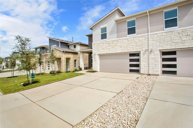 a backyard of a house with a fountain table and chairs