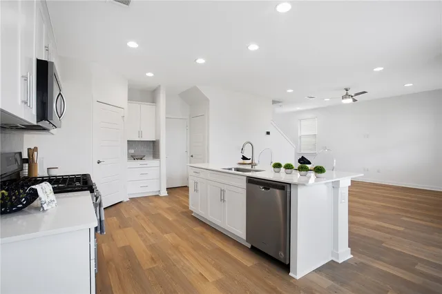 a kitchen with a sink a stove and cabinets