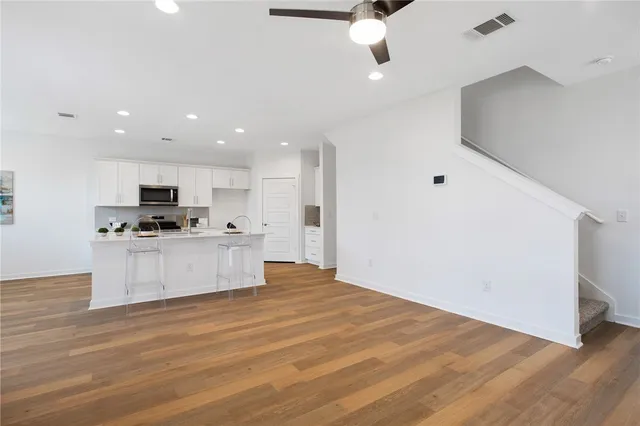 a view of kitchen with granite countertop cabinets and refrigerator