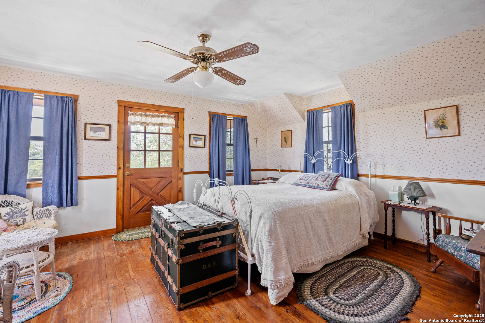 667 Medina Bend Road Medina, TX 78055 - Photo 12 of 40 a bed room with a bed and a chandelier