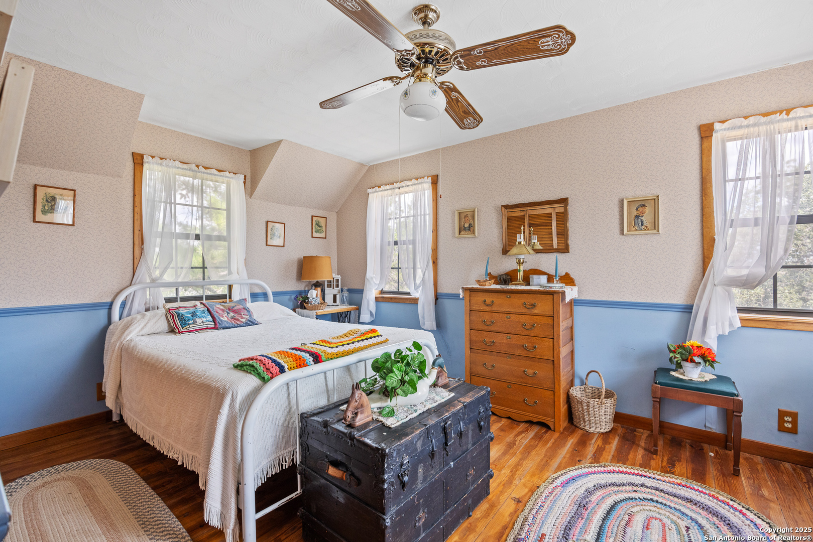 667 Medina Bend Road Medina, TX 78055 - Photo 14 of 40 a bedroom with a bed and wooden floor