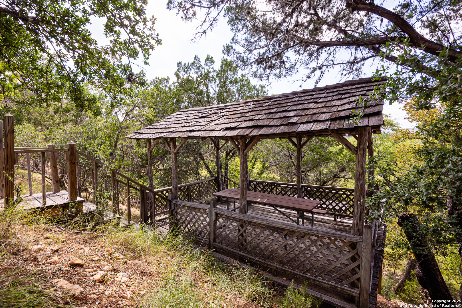667 Medina Bend Road Medina, TX 78055 - Photo 20 of 40 a view of a wooden deck with a backyard