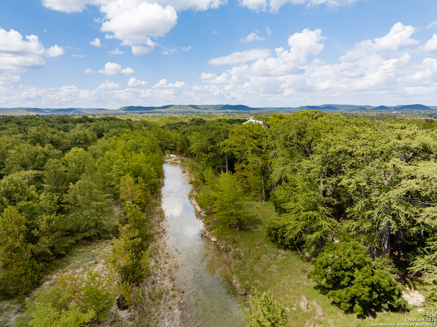 667 Medina Bend Road Medina, TX 78055 - Photo 33 of 40 a view of a lake with houses in back