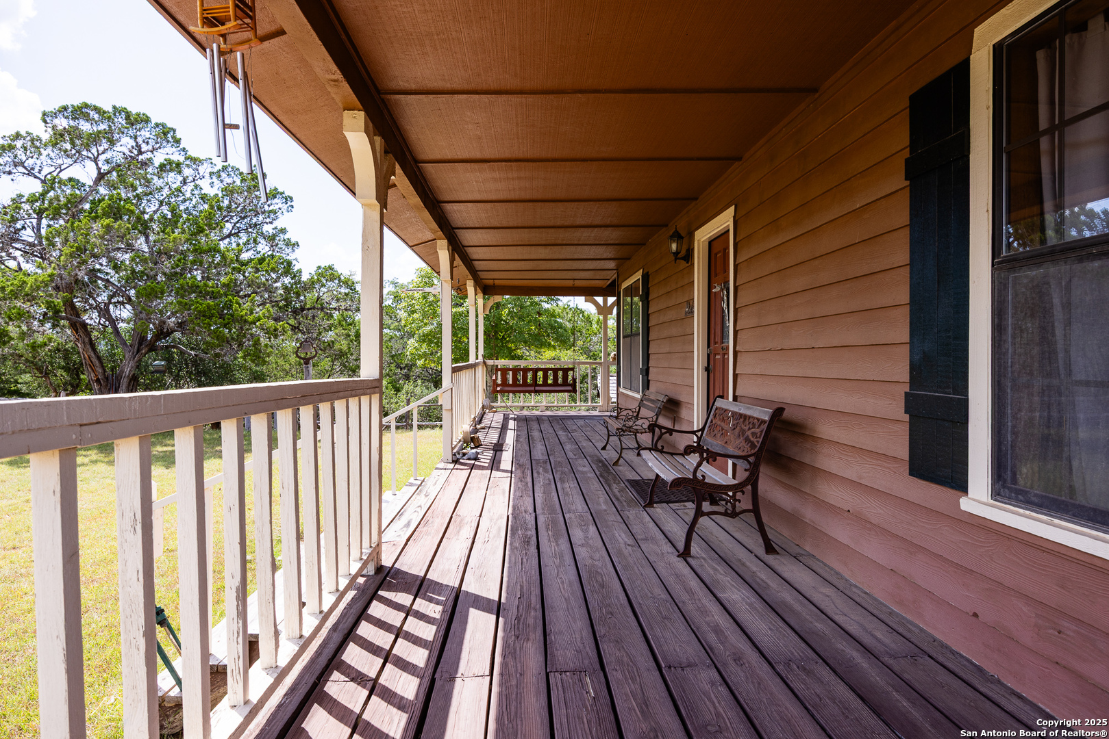 667 Medina Bend Road Medina, TX 78055 - Photo 5 of 40 a view of balcony with wooden floor and outdoor seating
