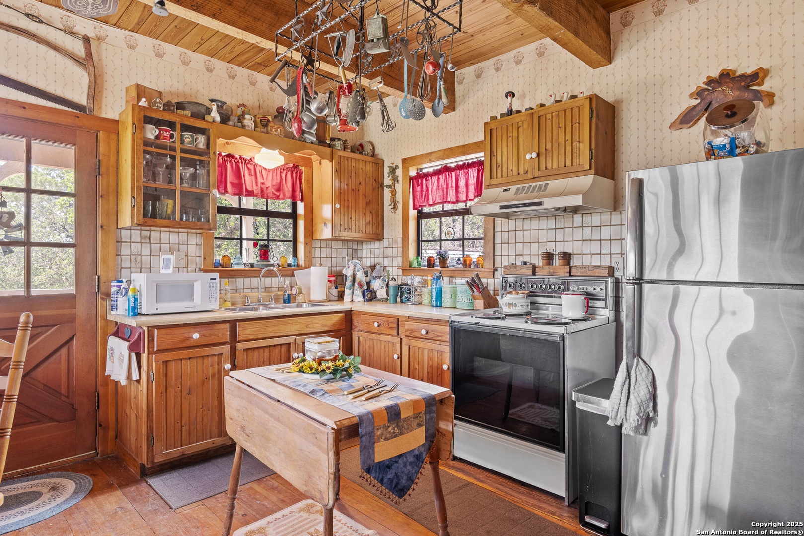 667 Medina Bend Road Medina, TX 78055 - Photo 9 of 40 a kitchen that has a lot of cabinets in it and a refrigerator