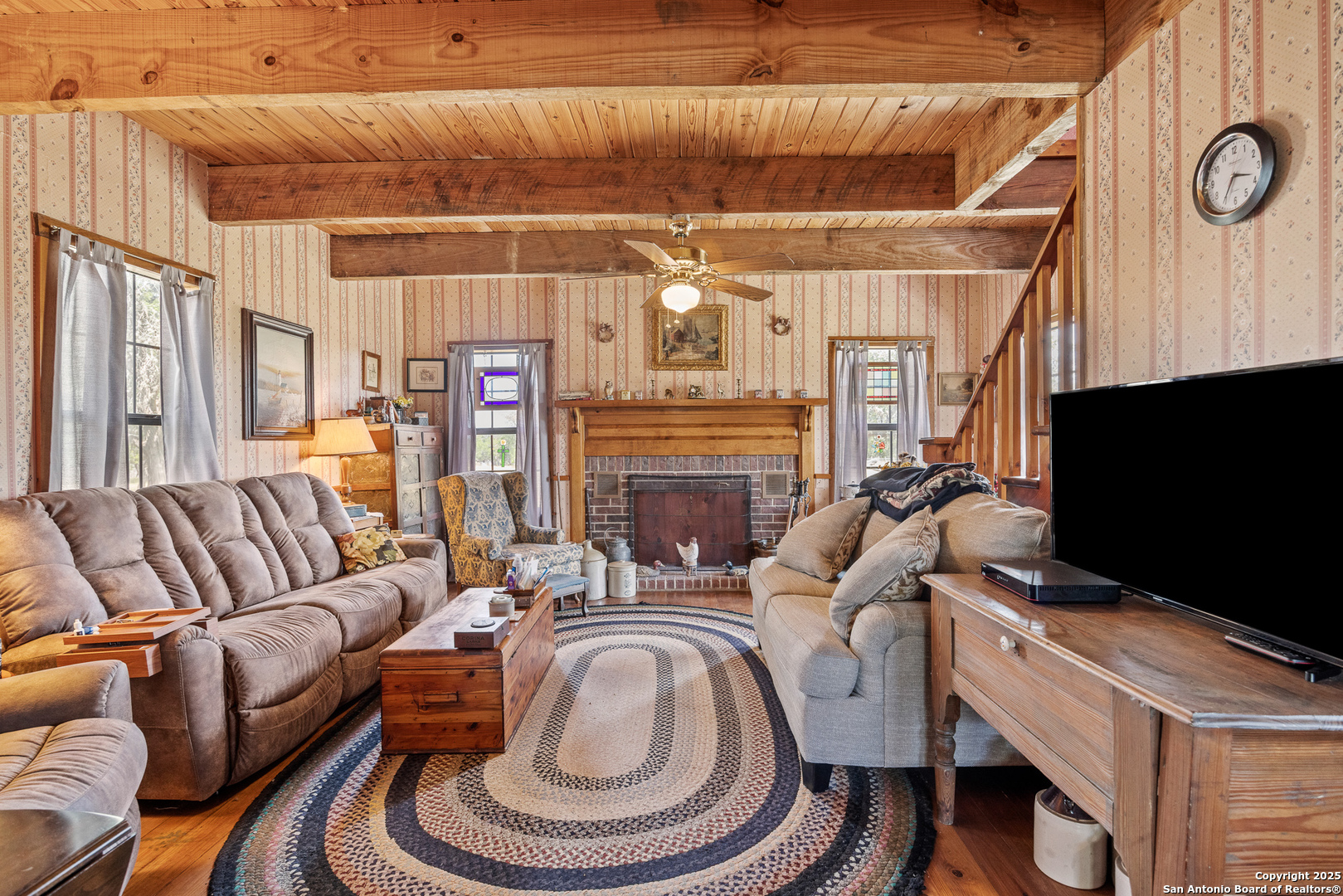 667 Medina Bend Road Medina, TX 78055 - Photo 10 of 40 a living room with furniture a flat screen tv and a fireplace
