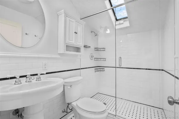 a bathroom with a sink a toilet and a mirror