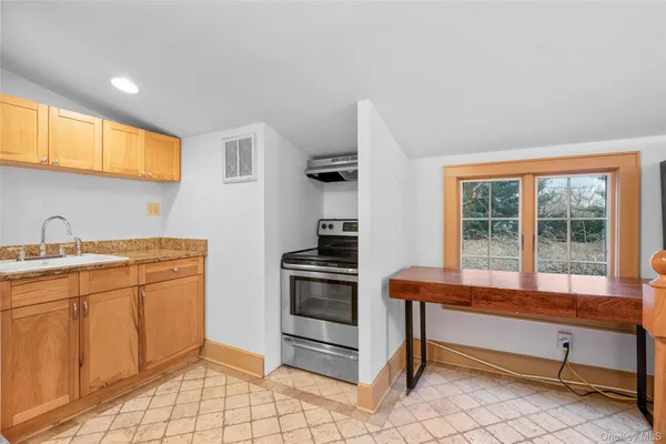 a kitchen with a stove and a sink