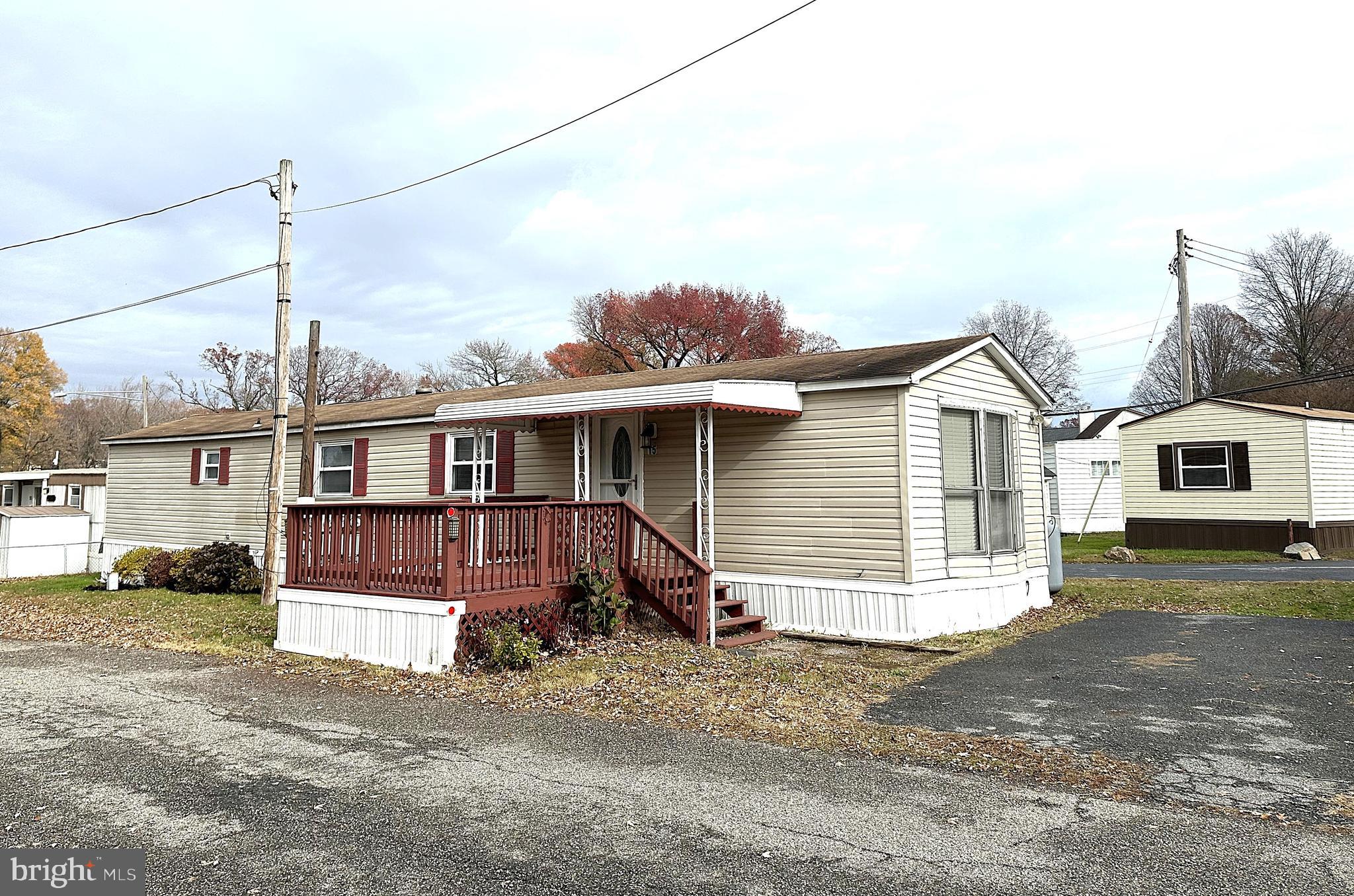a view of a house with a large space and a road