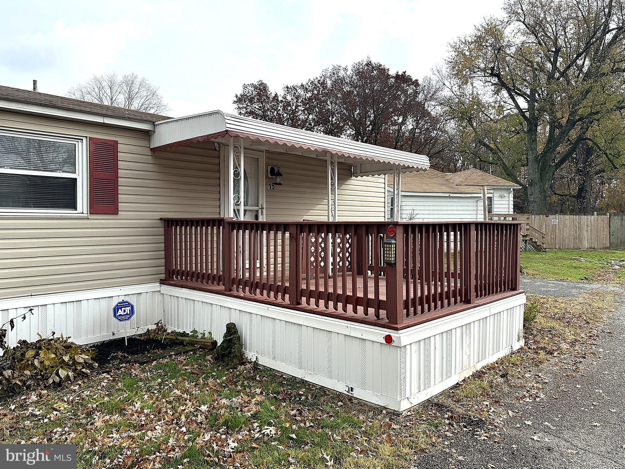 2400 Lincoln Avenue, Unit 15 Sparrows Point, MD 21219 - Photo 24 of 24 a view of a wooden house with a small yard and wooden fence
