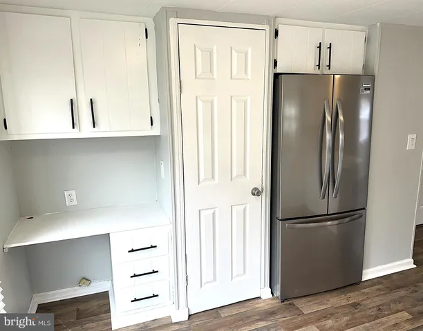 a kitchen with stainless steel appliances a refrigerator and cabinets
