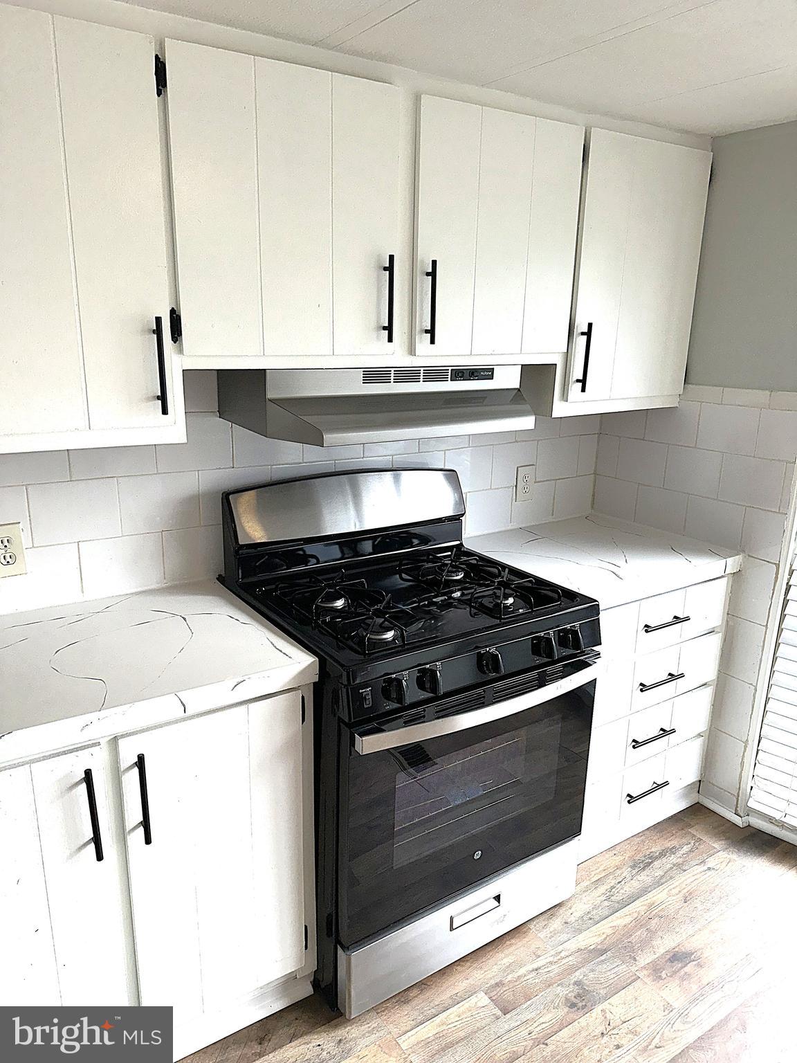 2400 Lincoln Avenue, Unit 15 Sparrows Point, MD 21219 - Photo 5 of 24 a kitchen with granite countertop a stove and a sink