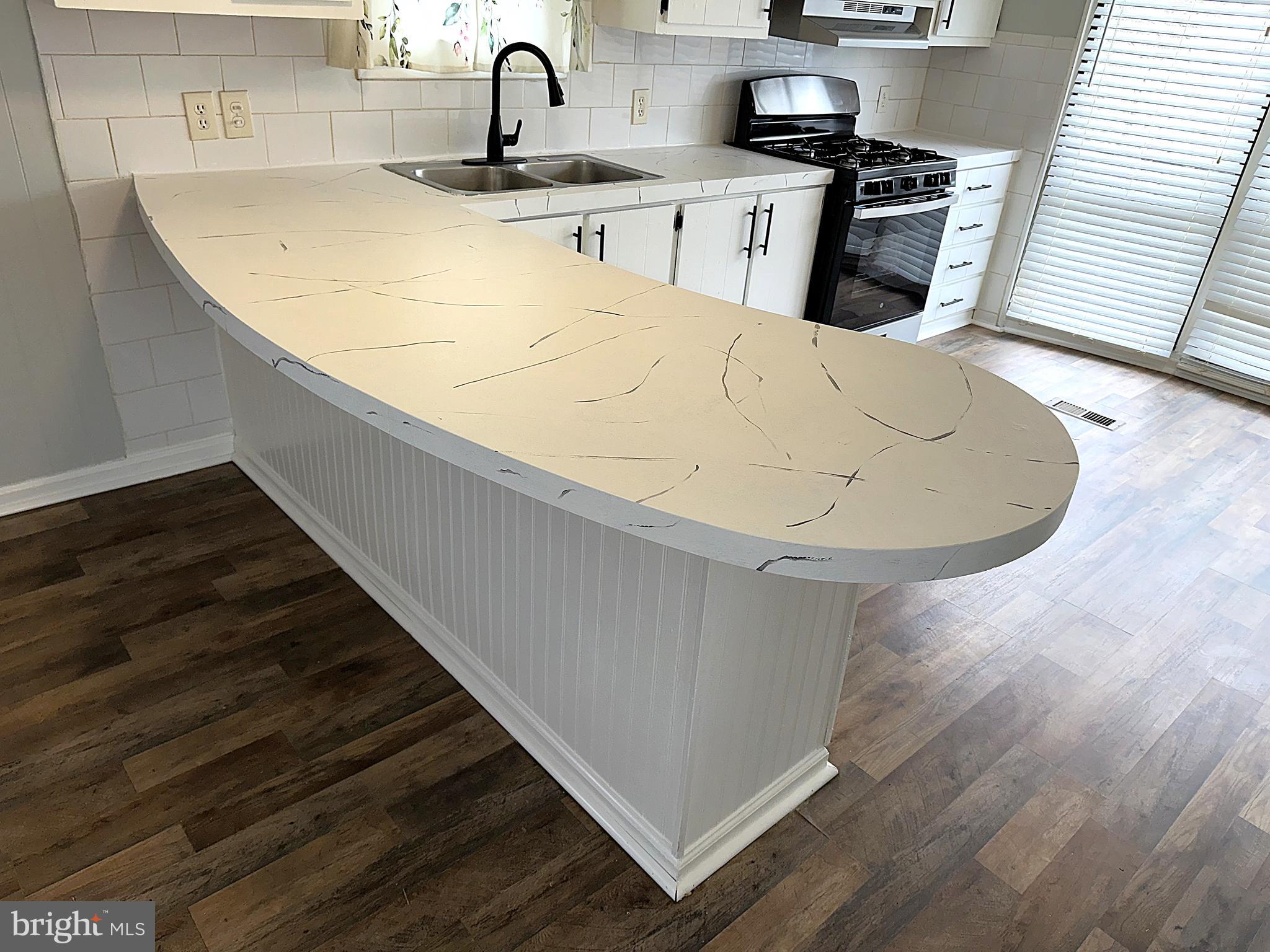 2400 Lincoln Avenue, Unit 15 Sparrows Point, MD 21219 - Photo 8 of 24 a kitchen with a sink and a stove