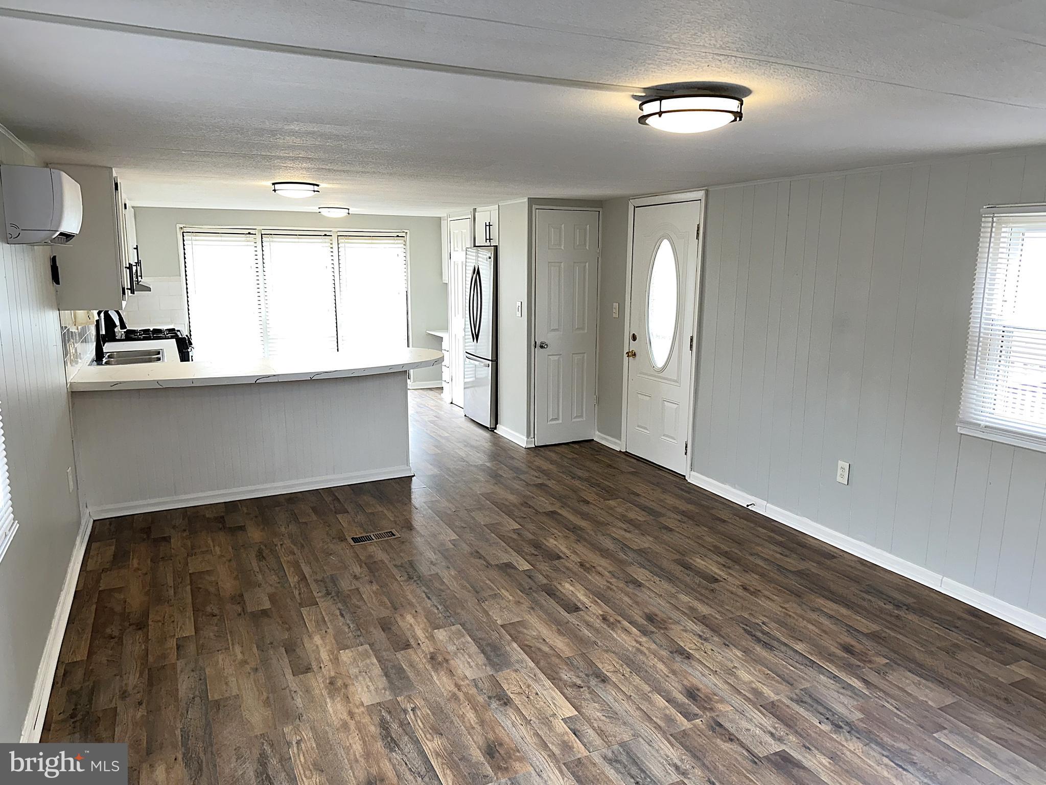 2400 Lincoln Avenue, Unit 15 Sparrows Point, MD 21219 - Photo 9 of 24 an empty room with wooden floor and windows