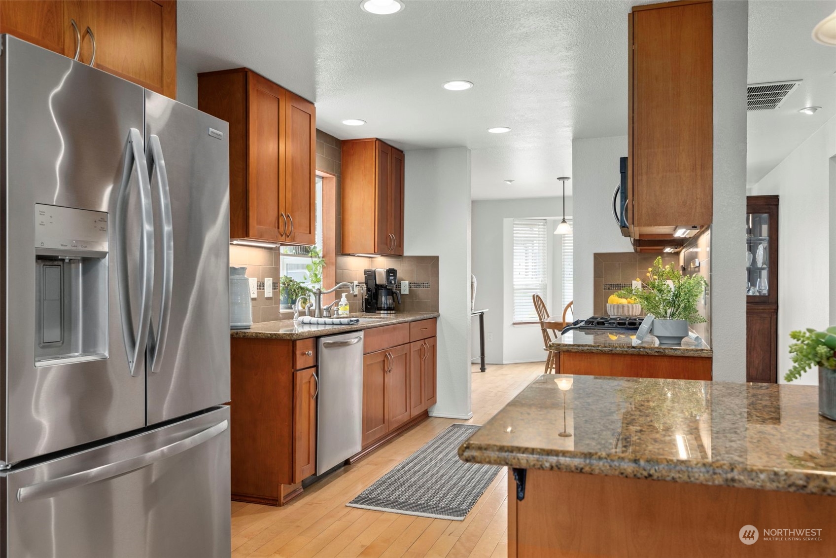 2305 Main Court South Renton, WA 98055 - Photo 11 of 39 a kitchen with stainless steel appliances granite countertop a refrigerator a stove and a sink