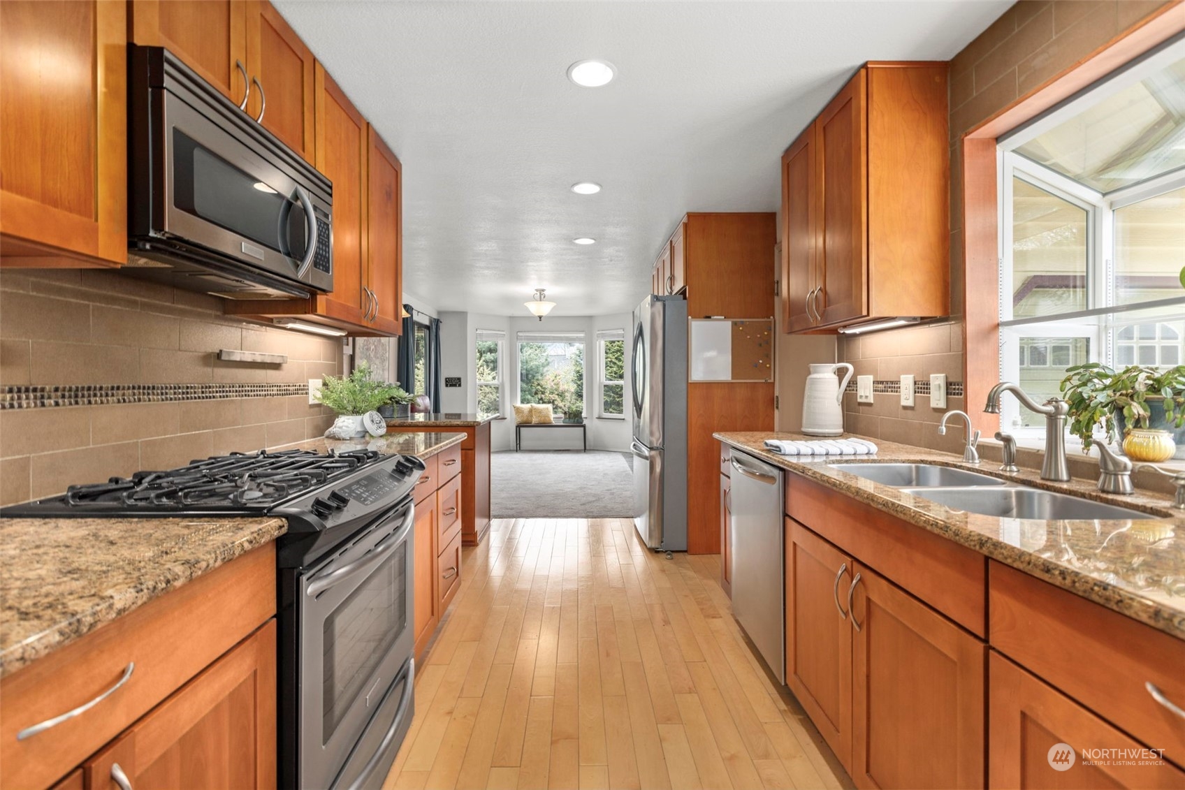 2305 Main Court South Renton, WA 98055 - Photo 10 of 39 a kitchen with stainless steel appliances granite countertop a stove a sink and a microwave