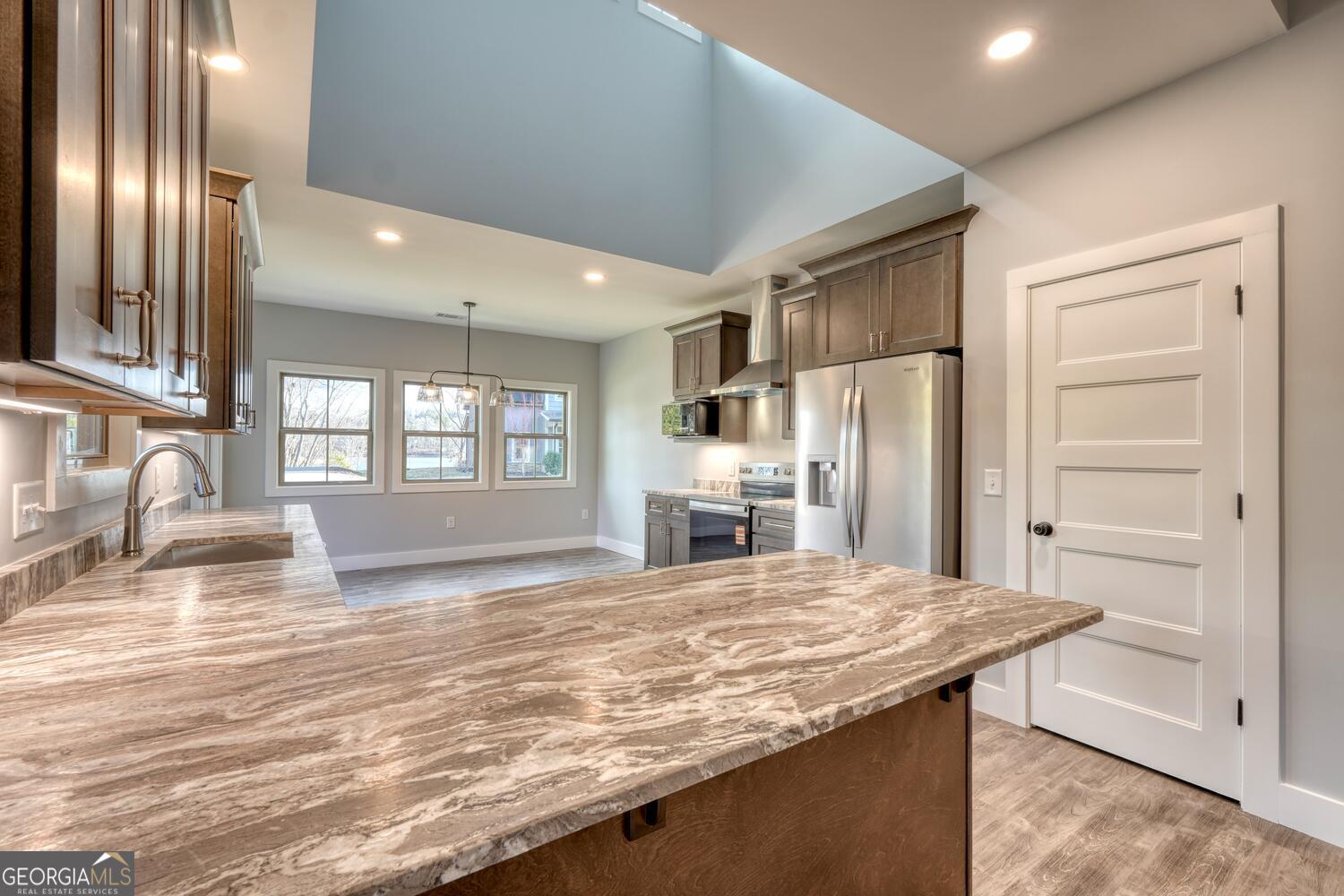 98 Brett Way, Unit F Hiawassee, GA 30546 - Photo 12 of 40 a kitchen with kitchen island a sink stainless steel appliances and window