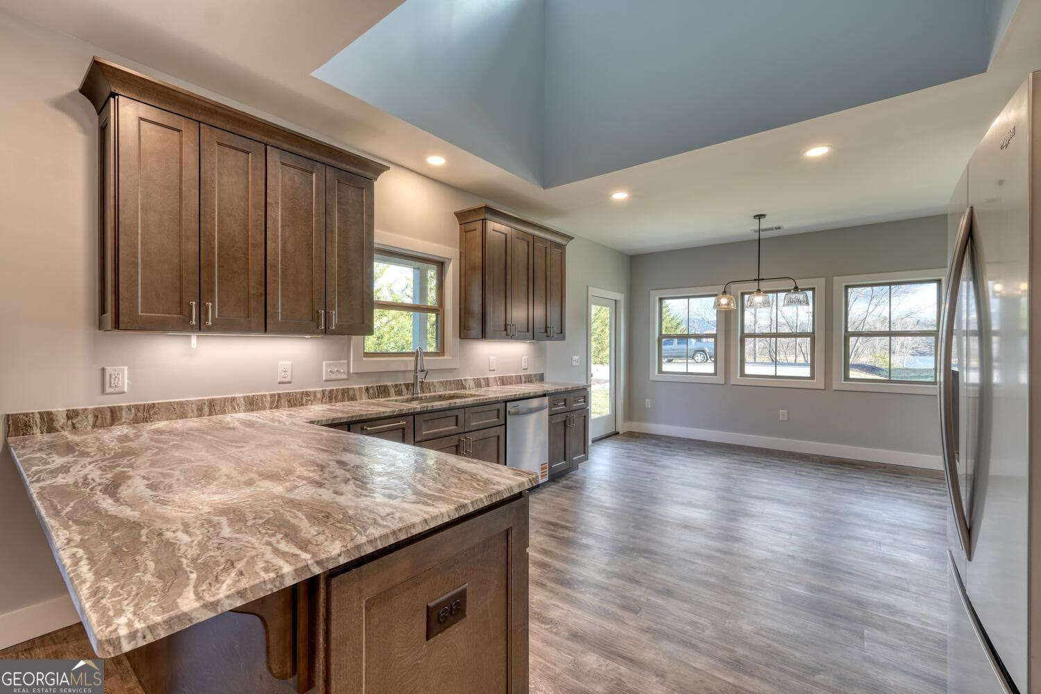 98 Brett Way, Unit F Hiawassee, GA 30546 - Photo 13 of 40 a kitchen with stainless steel appliances granite countertop wooden cabinets a oven a stove and a granite counter tops with wooden floors