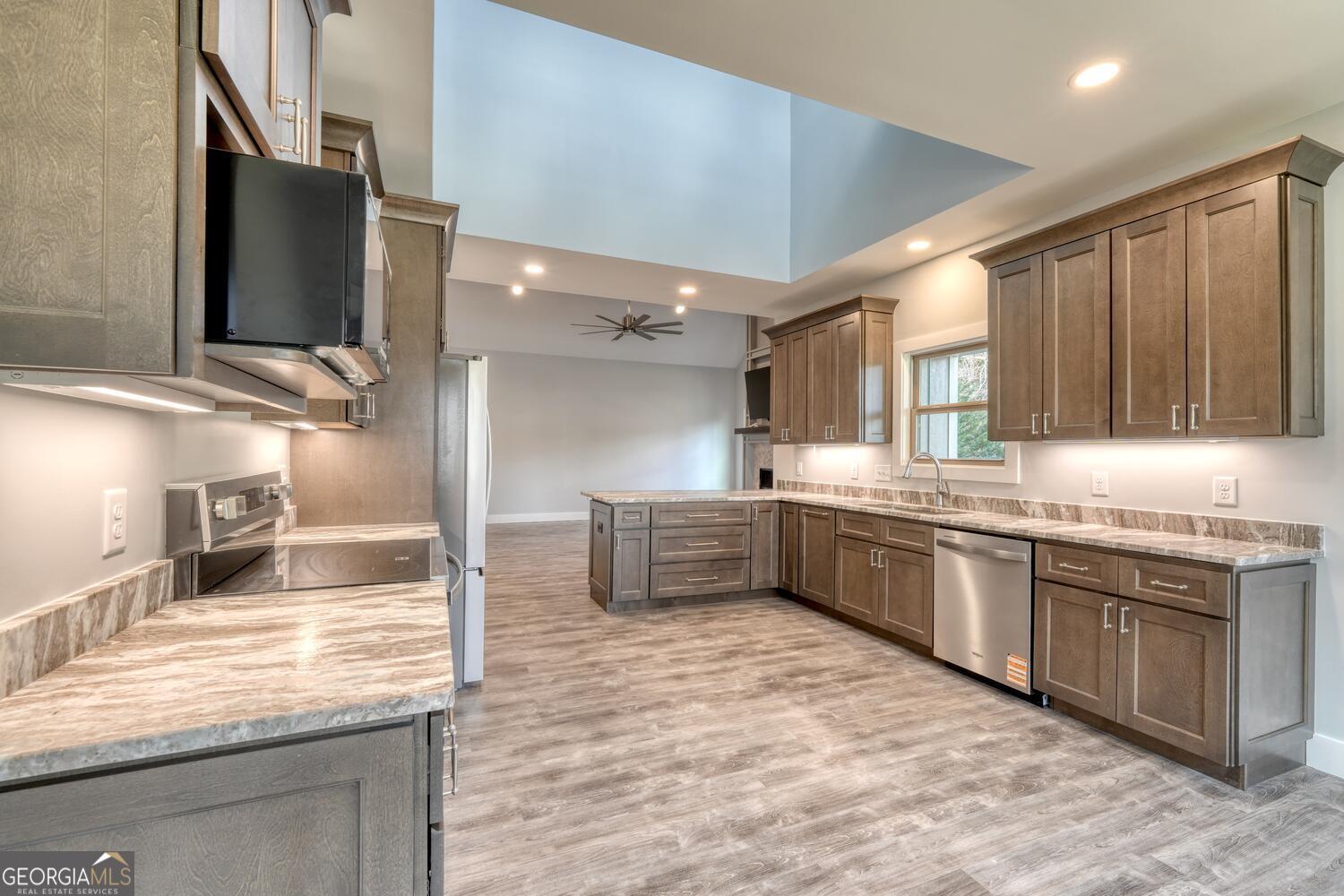 98 Brett Way, Unit F Hiawassee, GA 30546 - Photo 14 of 40 a large kitchen with kitchen island a sink stainless steel appliances and cabinets