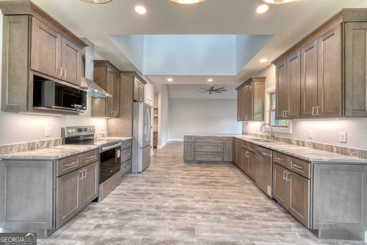 98 Brett Way, Unit F Hiawassee, GA 30546 - Photo 15 of 40 a large kitchen with stainless steel appliances and a sink
