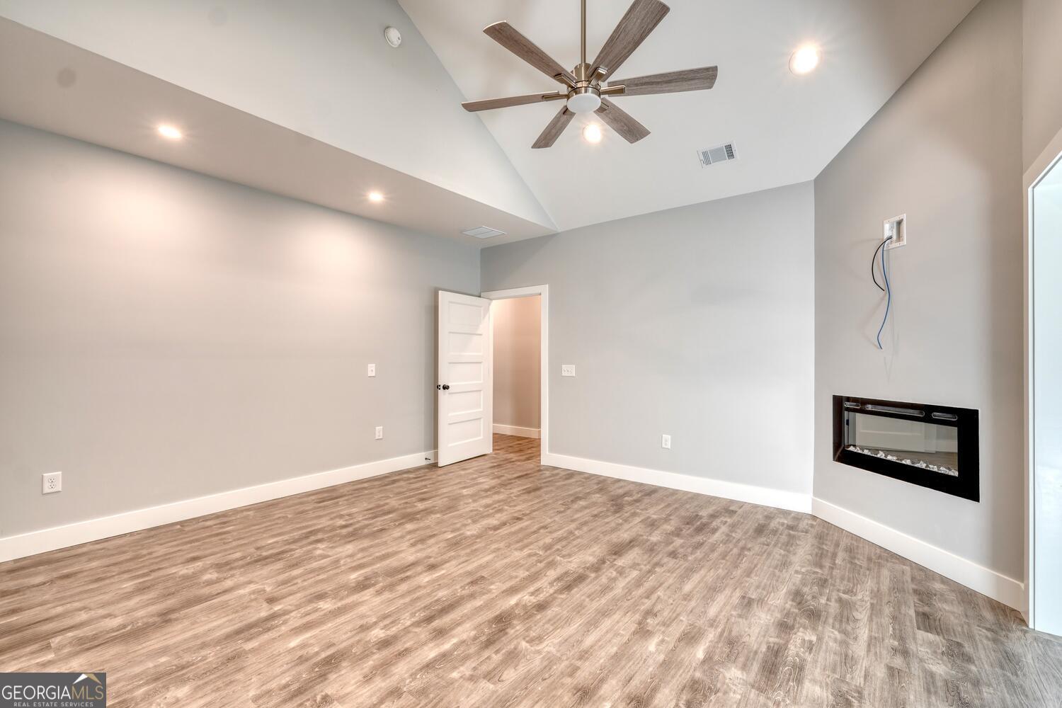 98 Brett Way, Unit F Hiawassee, GA 30546 - Photo 19 of 40 an empty room with a ceiling fan and a window