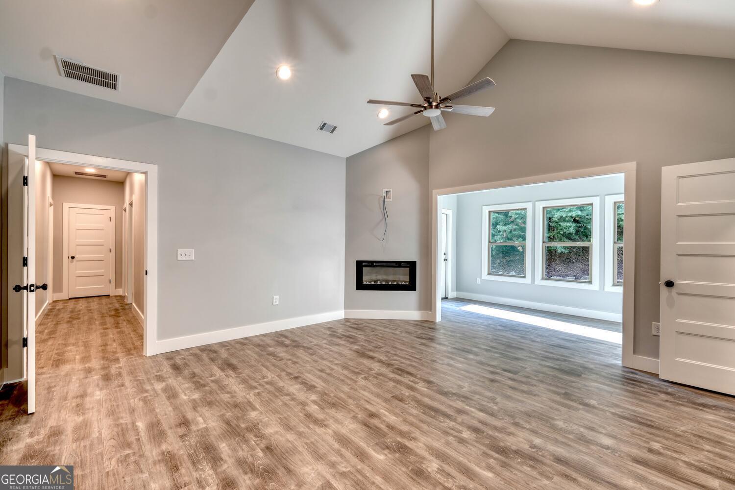 98 Brett Way, Unit F Hiawassee, GA 30546 - Photo 20 of 40 a view of an empty room with wooden floor and a window