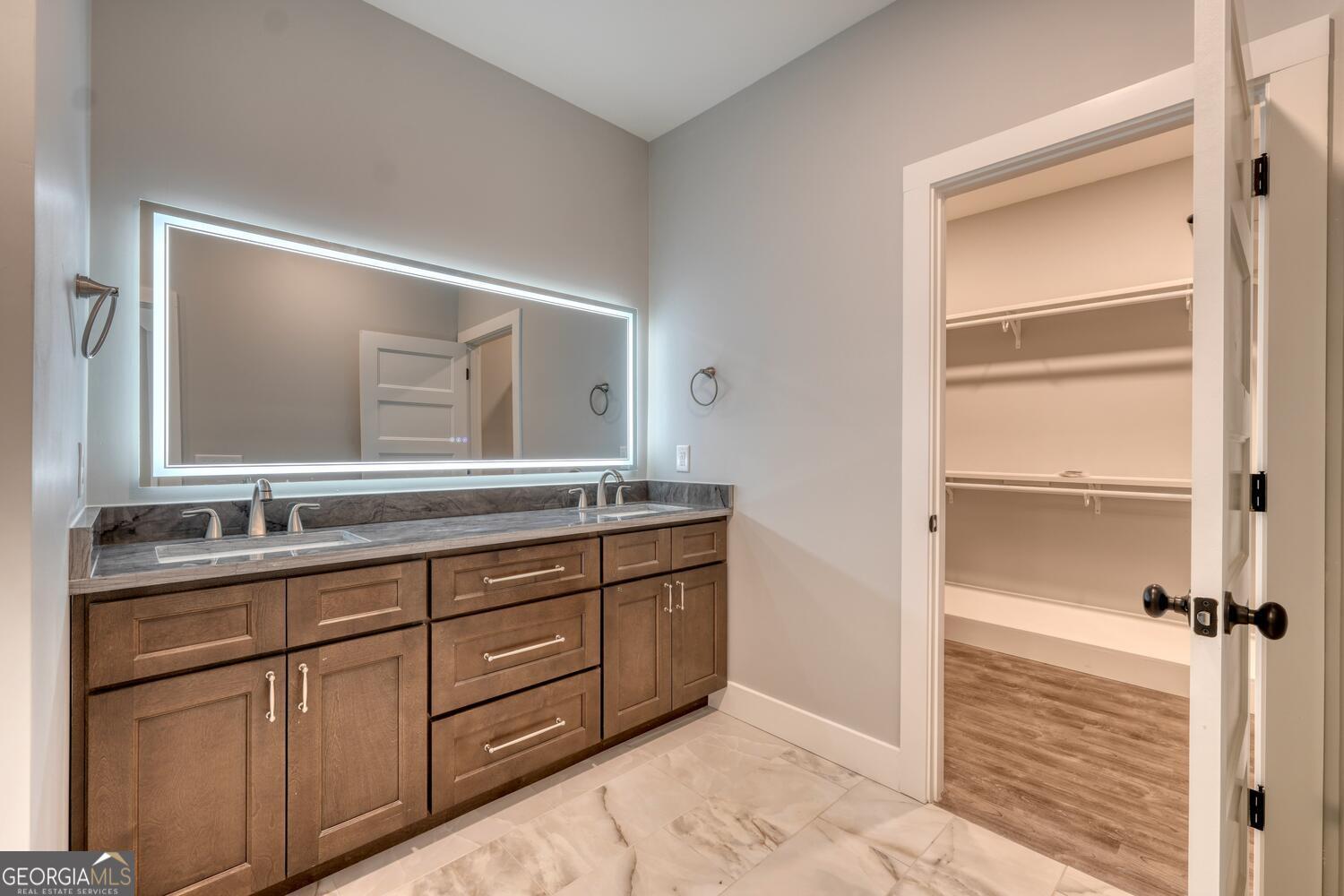 98 Brett Way, Unit F Hiawassee, GA 30546 - Photo 22 of 40 a bathroom with a granite countertop sink and a mirror