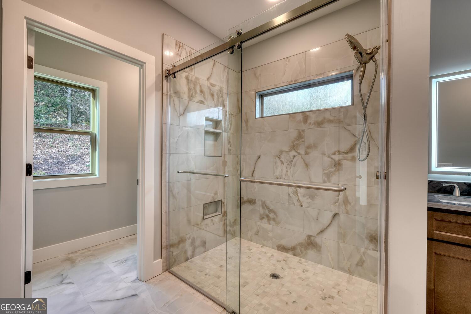 98 Brett Way, Unit F Hiawassee, GA 30546 - Photo 23 of 40 a bathroom with a glass shower door