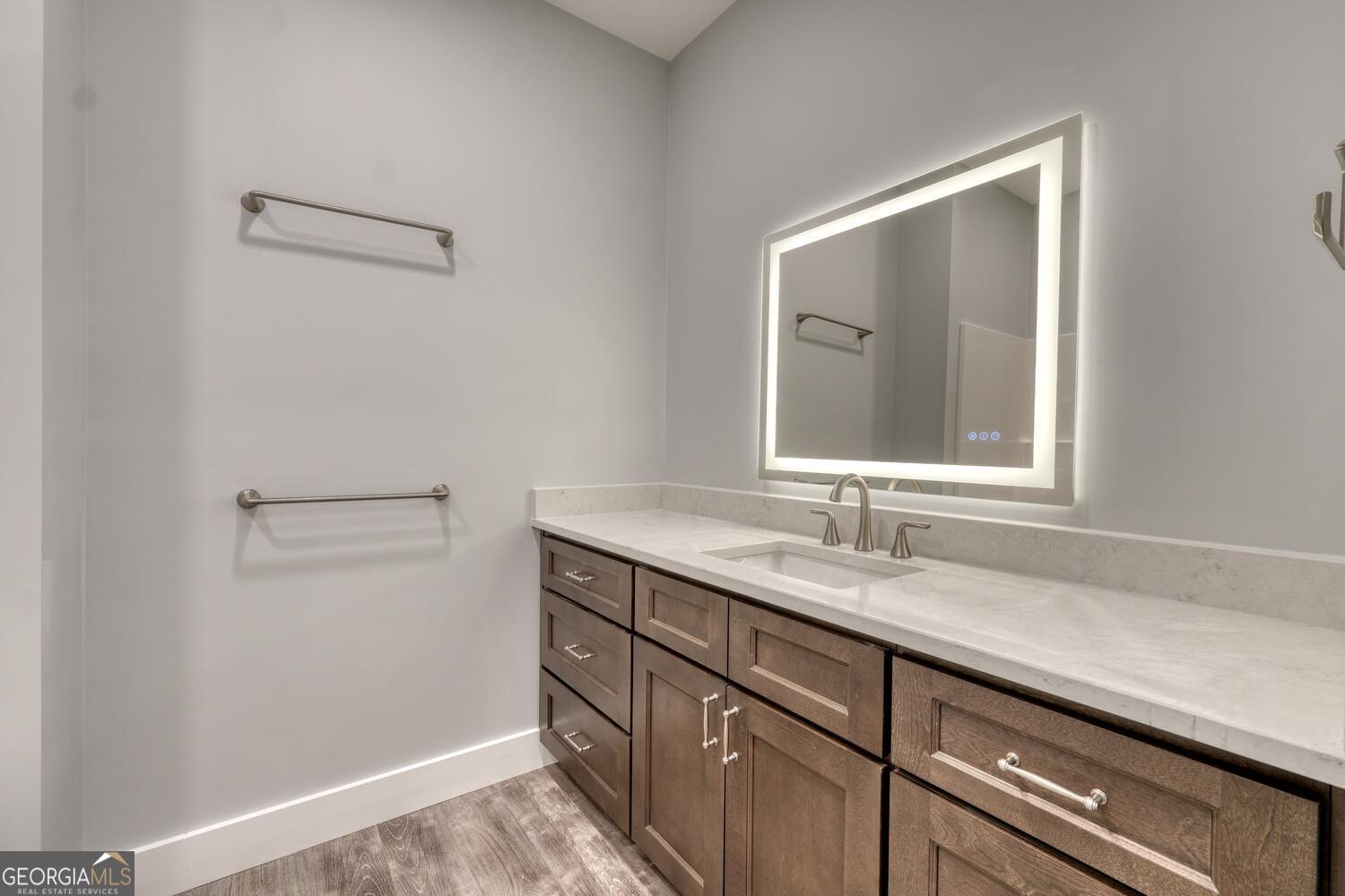 98 Brett Way, Unit F Hiawassee, GA 30546 - Photo 26 of 40 a bathroom with a granite countertop sink and a mirror