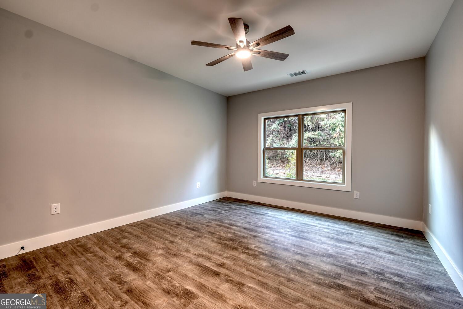 98 Brett Way, Unit F Hiawassee, GA 30546 - Photo 27 of 40 a view of empty room with wooden floor and fan
