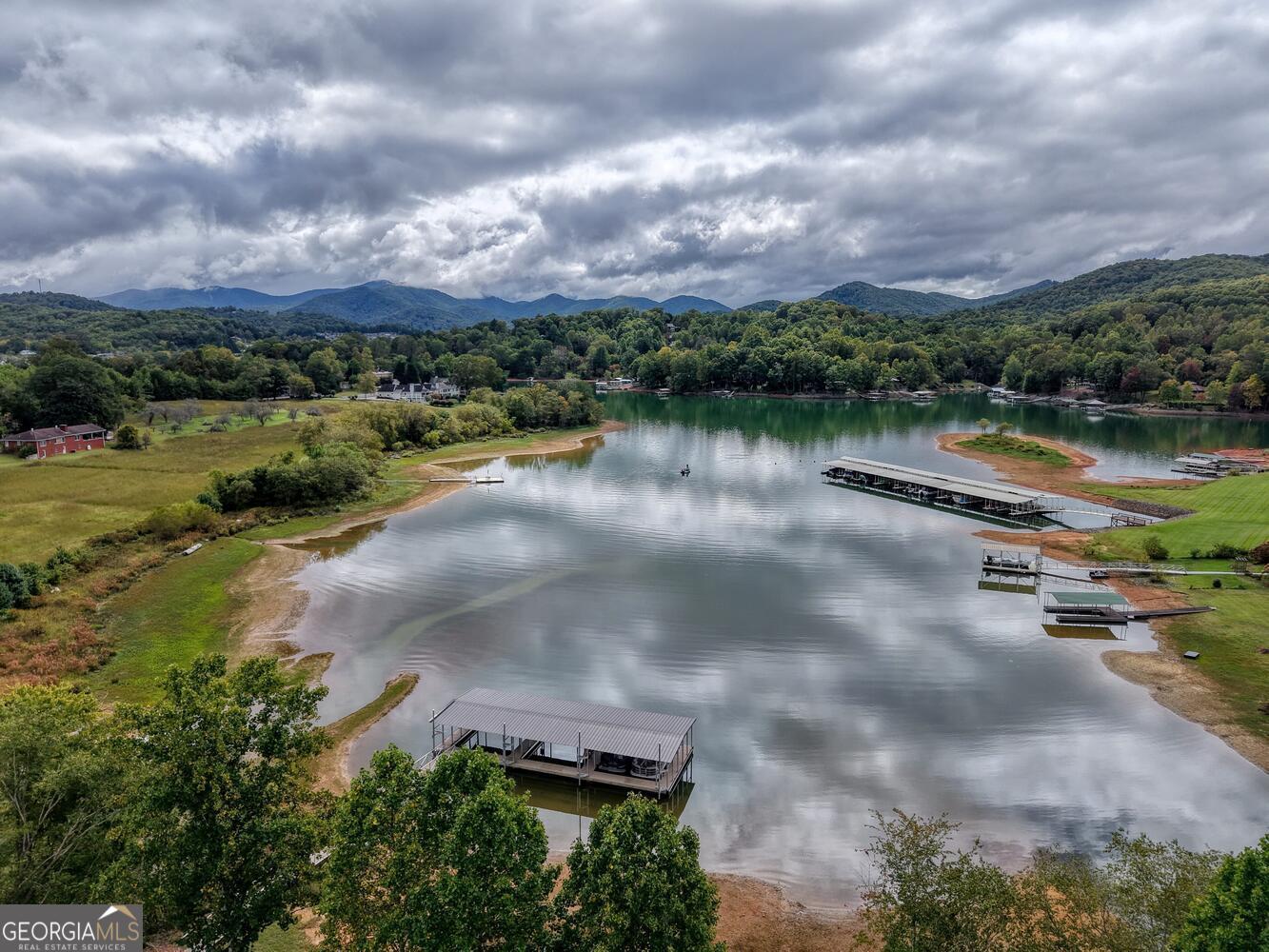 98 Brett Way, Unit F Hiawassee, GA 30546 - Photo 3 of 40 a view of a lake with houses in the back