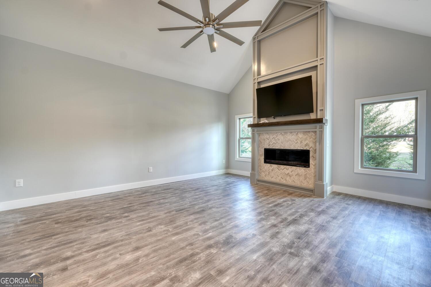 98 Brett Way, Unit F Hiawassee, GA 30546 - Photo 9 of 40 a view of empty room with a fireplace and a flat screen tv