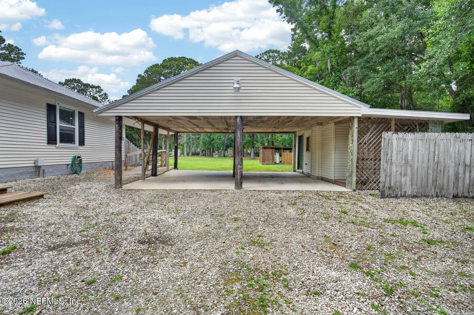 1950 Lightsey Road St. Augustine, FL 32084 - Photo 7 of 57 a house with lots of trees in the background