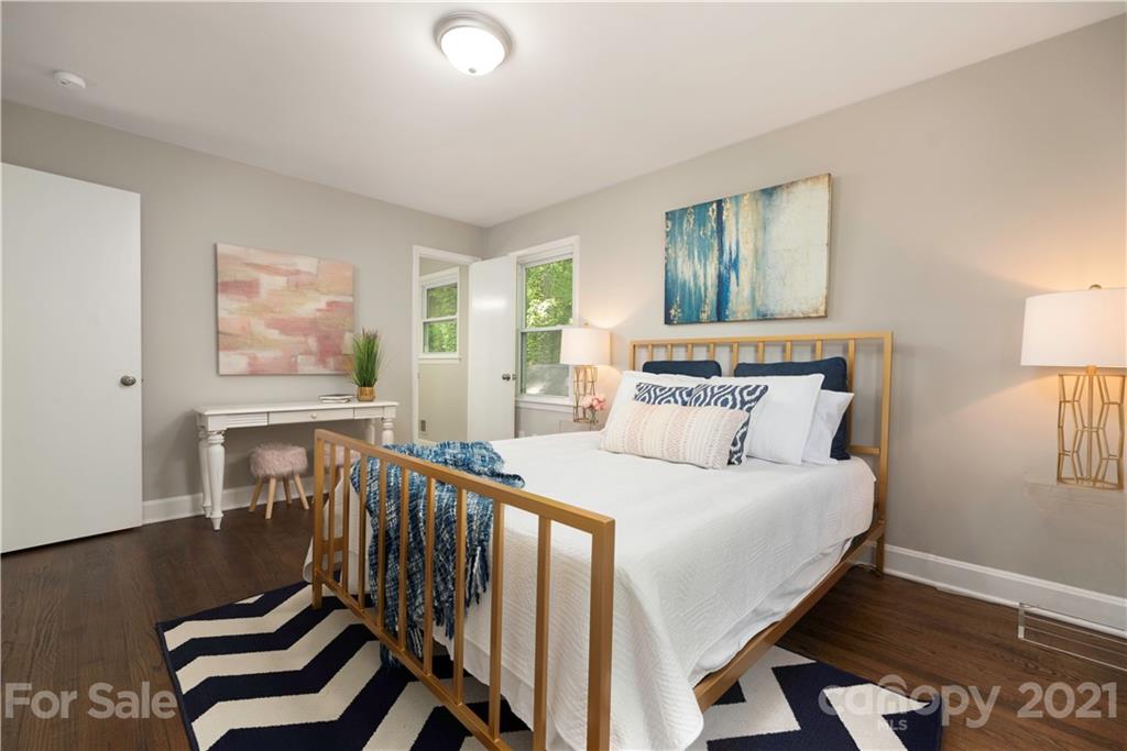 7316 Watercrest Road Charlotte, NC 28210 - Photo 15 of 28 a bedroom with a bed and wooden floor