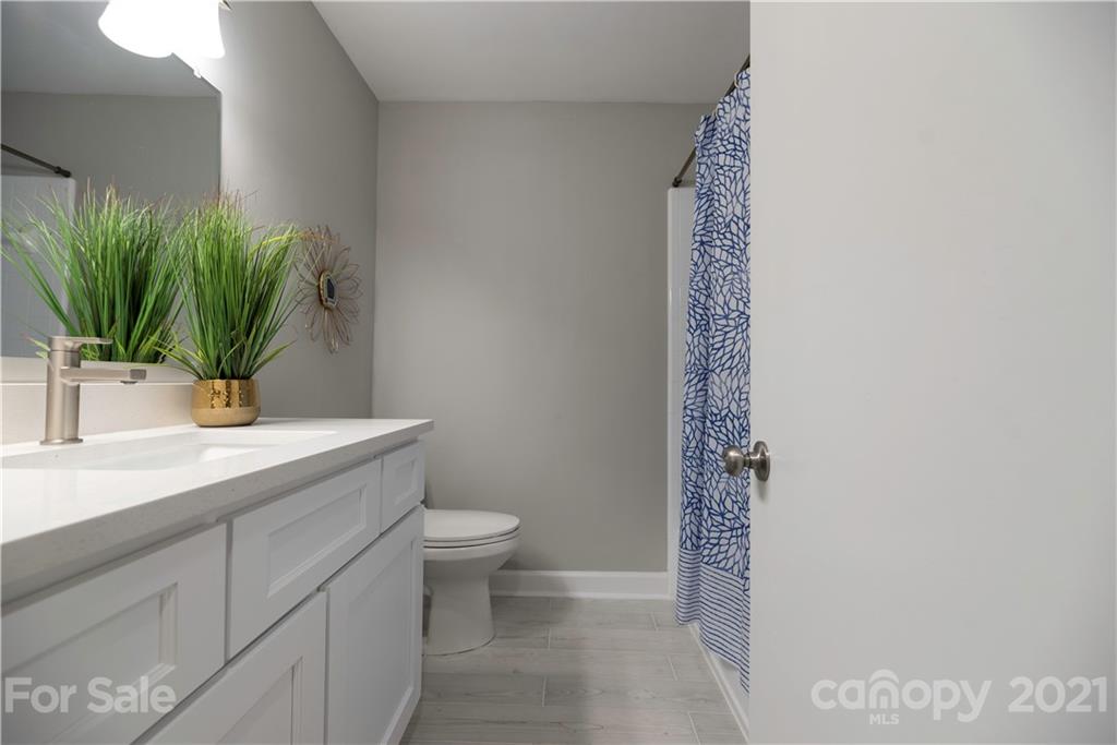 7316 Watercrest Road Charlotte, NC 28210 - Photo 17 of 28 a bathroom with a sink a toilet and a mirror