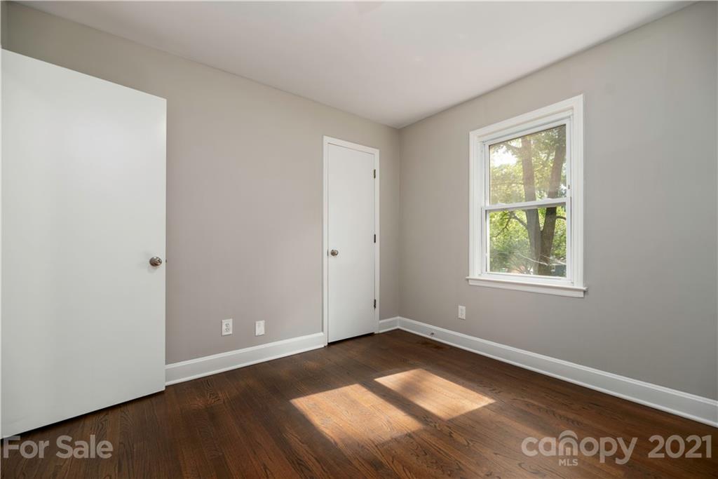 7316 Watercrest Road Charlotte, NC 28210 - Photo 19 of 28 an empty room with wooden floor and windows