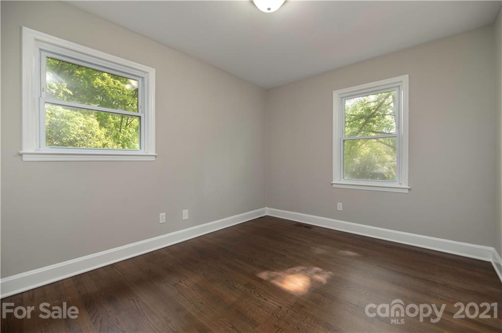 7316 Watercrest Road Charlotte, NC 28210 - Photo 21 of 28 an empty room with wooden floor and windows