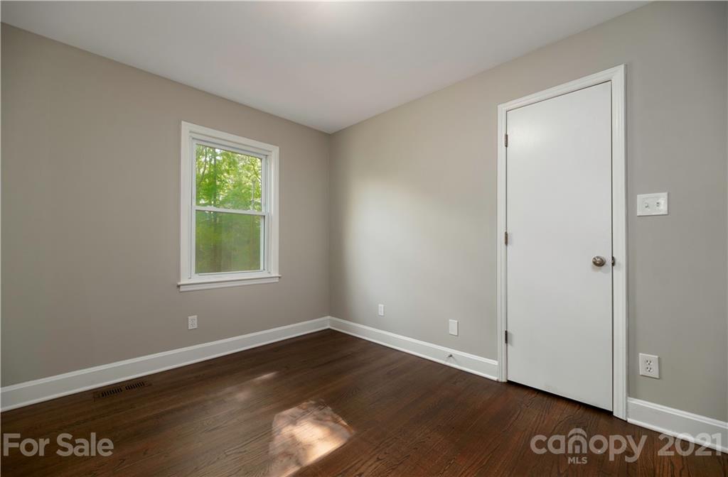 7316 Watercrest Road Charlotte, NC 28210 - Photo 22 of 28 a view of an empty room with wooden floor and a window