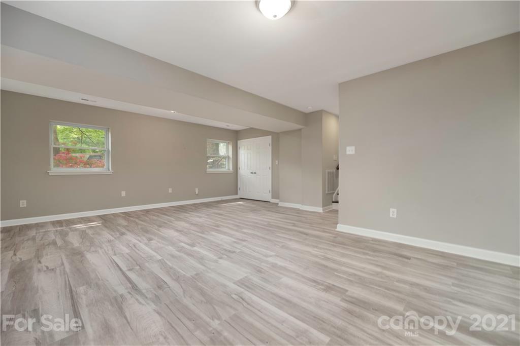 7316 Watercrest Road Charlotte, NC 28210 - Photo 24 of 28 an empty room with wooden floor and windows