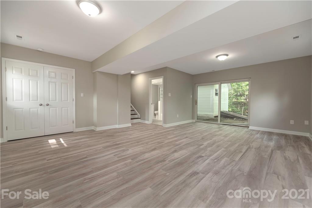 7316 Watercrest Road Charlotte, NC 28210 - Photo 25 of 28 a view of an empty room with wooden floor and a window