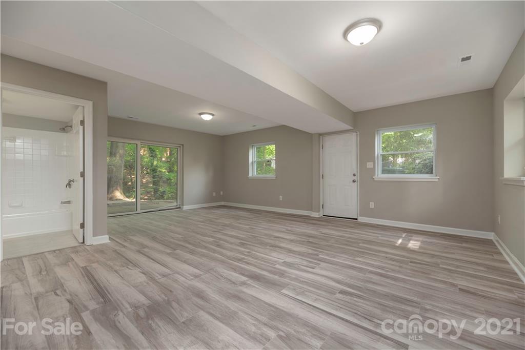 7316 Watercrest Road Charlotte, NC 28210 - Photo 26 of 28 an empty room with wooden floor and windows