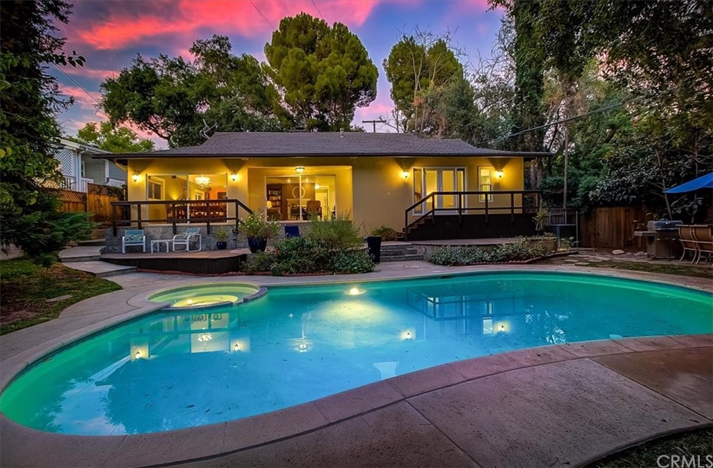 a view of a swimming pool with an outdoor space and seating area